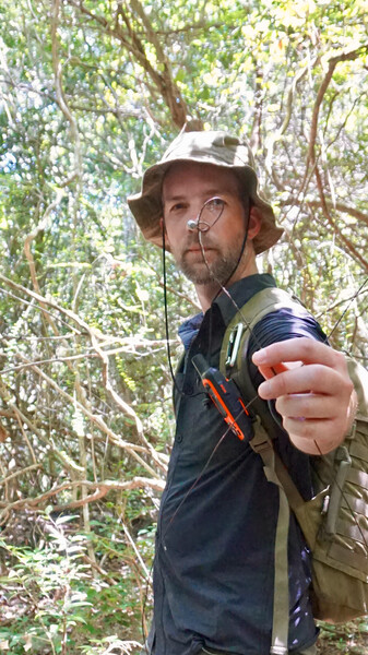 James Slade, Re:wild's wildlife crime prevention officer, removes a snare from a forest in the Annamites. (Photo by Andrew Tilker, Re:wild)