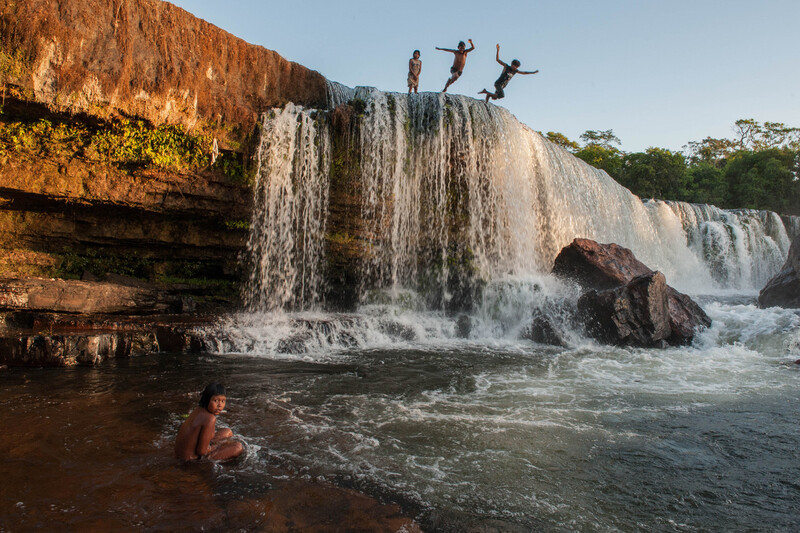 Kayapó Children jumping into the waterfalls of the Rio Pequeno, Xingú region