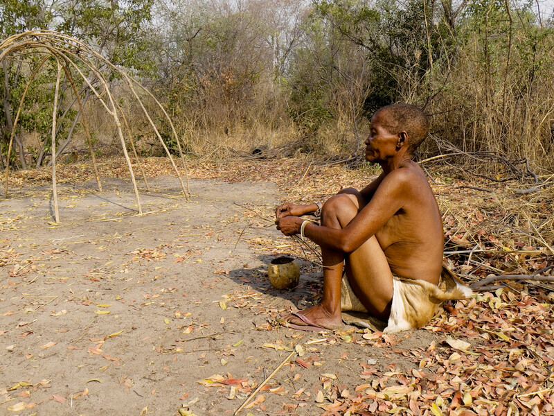 A Khwe San elder making a traditional grass basket