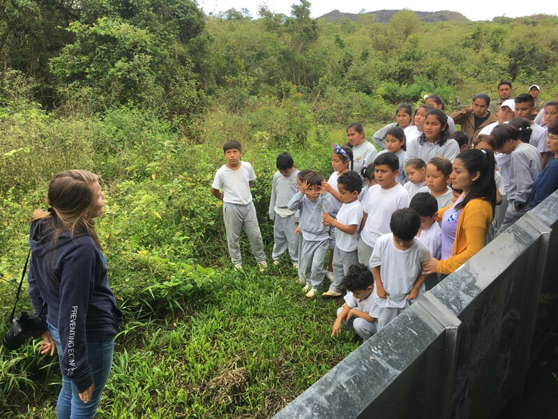 Paula A. Castaño, a wildlife veterinarian and island restoration specialist with Island Conservation (left), releasing finches on Floreana Island with children from the local community. Local communities are critical partners for Re:wild, Island Conservation and the Galápagos National Park Directorate as they embark on a new bold initiative to protect and restore the Galápagos. Local efforts to protect and restore ecosystems, prevent the introduction of invasive species, return endangered species to their wild homes and bolster the economy through ecotourism will help guide the new initiative by Re:wild, Island Conservation and the Galápagos National Park Directorate. (Photo courtesy of Paula A. Castaño, Island Conservation)