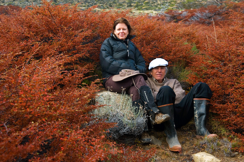 Kris and Doug Tompkins take a break out of the wind among the red autumn colors of Lenga bushes, during a trek in Estancia El Rincon, at the base of Cerro San Lorenzo and adjacent to Parque Nacional Perito Moreno, in Argentine Patagonia