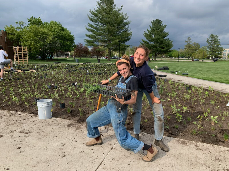 Grace Duffy and Jacy Highbarger volunteering during Grinnell College's prairie restoration project.  Photo by Re:wild Your Campus